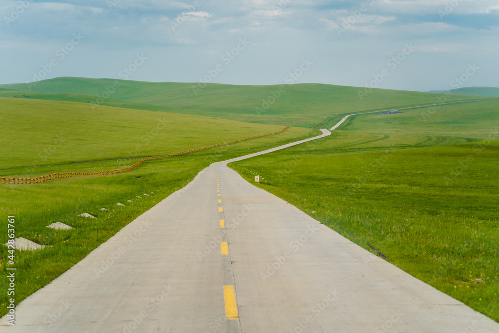 A highway road on Hulunbuir Grasslands, China, summer time. A highway road on Hulunbuir Grasslands, China, summer time.