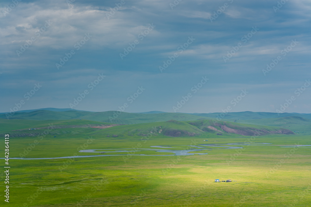 A river winding up on the Hulunbuir Grasslands, in Inner Mongolia, China, summer time.