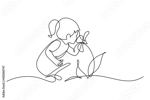 Child smelling flower in continuous line art drawing style. Small girl squatted down to sniff the fragrant flower. Black linear sketch isolated on white background. Vector illustration