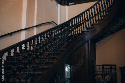 Anique wooden staircase in mansion, revolving staircase in old building photo