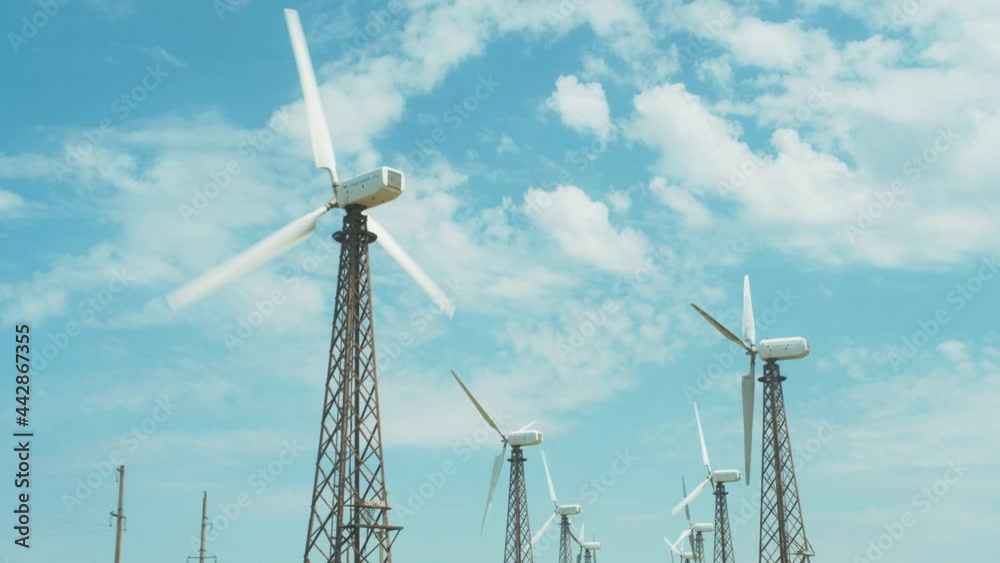 wind power plant at sunset with slow rotating tower blades generating alternative renewable energy. wind power plant at sunset with slow rotating tower blades generating alternative renewable energy.