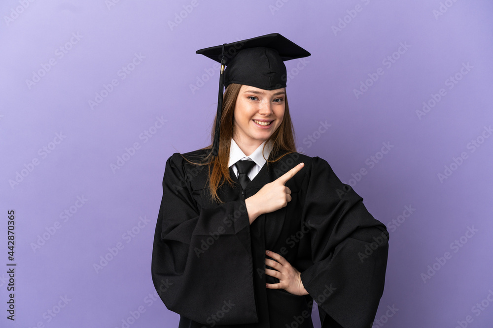 Young university graduate over isolated purple background pointing to the side to present a product Young university graduate over isolated purple background pointing to the side to present a product