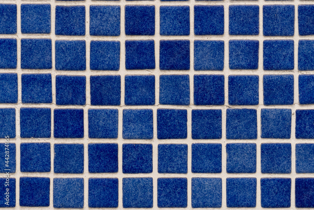 Small blue wall tiles close-up. Abstract colored background Small blue wall tiles close-up. Abstract colored background