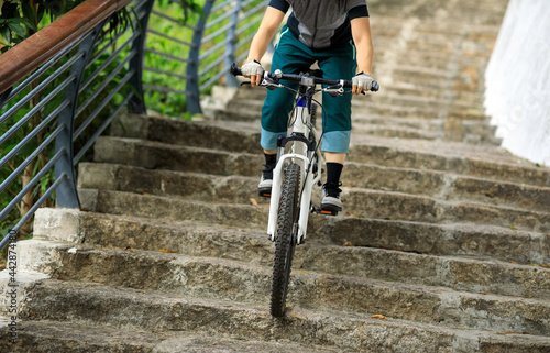 Fototapeta Naklejka Na Ścianę i Meble -  Woman freerider riding down stairs. Sports extreme and active lifestyle