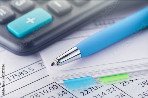 accounting document with pen and calculator. Concept of banking, financial report and financial audit.
