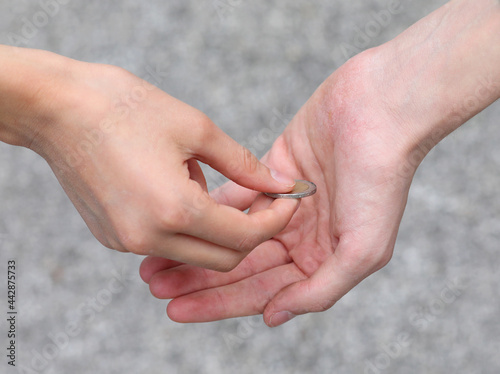 Slika na platnu two hands a coin while giving alms