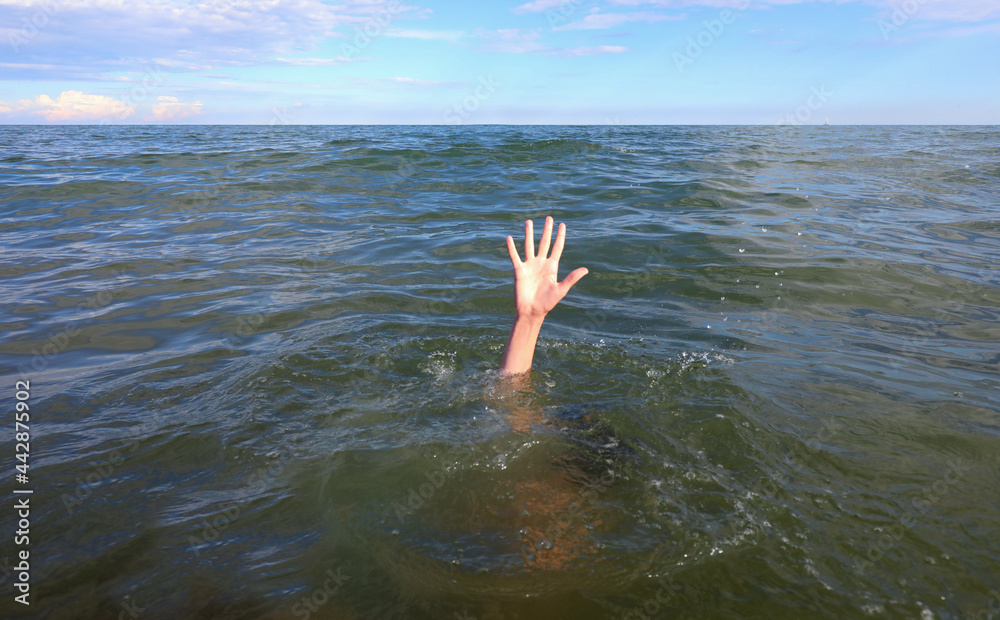 person in distress who is about to drown in the middle of the sea
