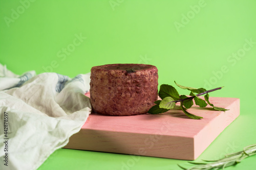 berry cheese suluguni with mint on pink board