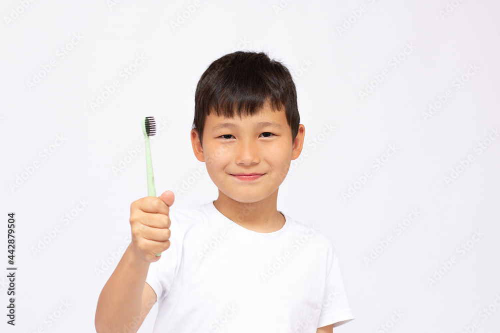 Asian boy brushing teeth, isolated on white background Asian boy brushing teeth, isolated on white background