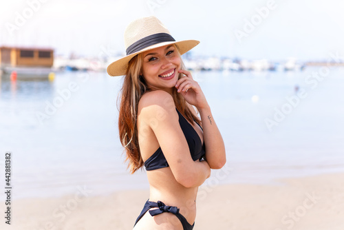 Young pretty blonde girl in swimsuit in summer holidays