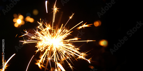 Burning sparkler flames. Silvester background banner panorama sparkling lights firework. Abstract Sparklers for celebration. Magic light. Happy new year and Merry Christmas concept.