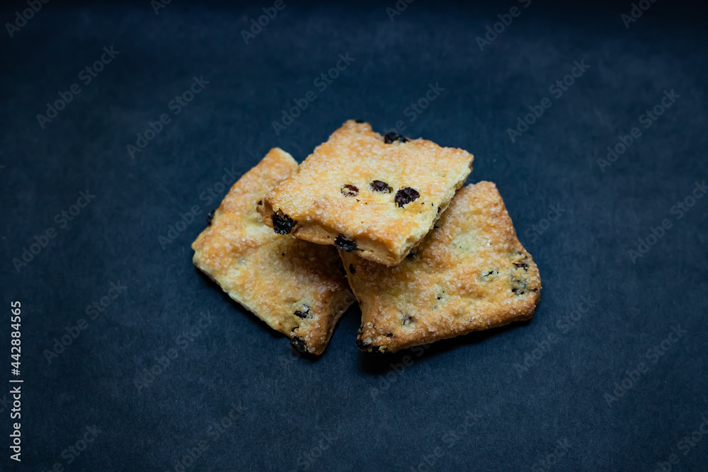 cookies with raisins on a black background