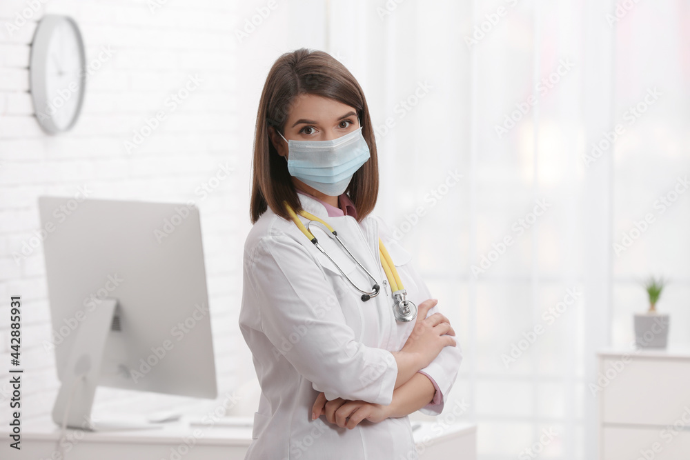 Pediatrician with protective mask and stethoscope in clinic Pediatrician with protective mask and stethoscope in clinic