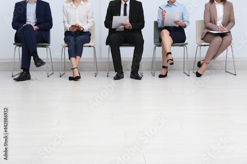 People waiting for job interview in office hall, closeup