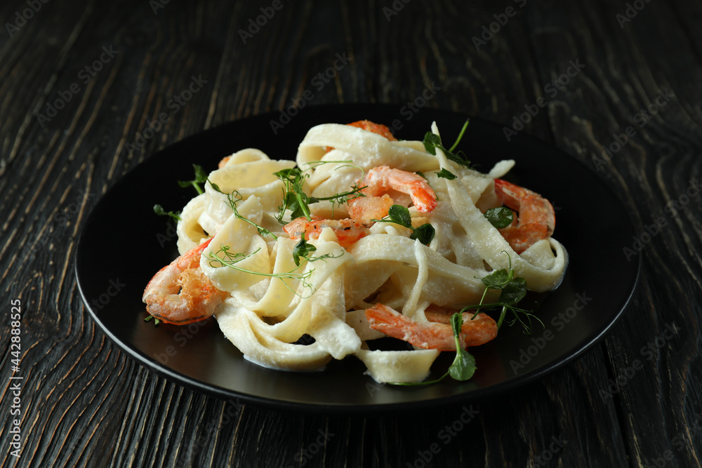 Plate of shrimp pasta on rustic wooden background Plate of shrimp pasta on rustic wooden background