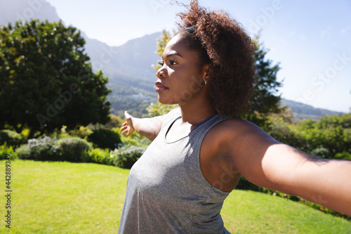 African american woman practicing yoga in sunny garden