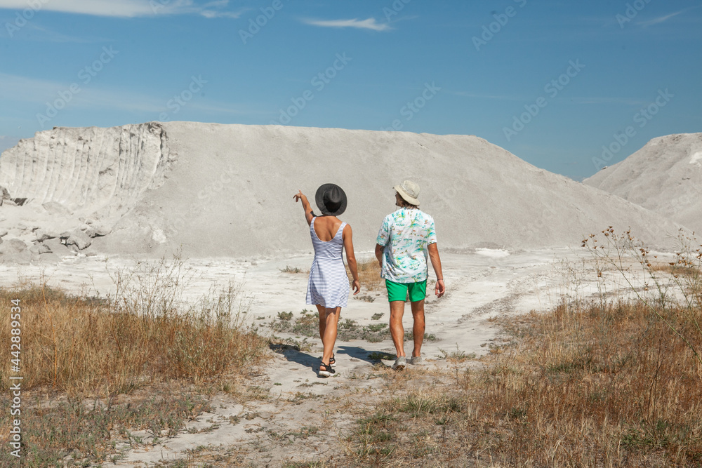 woman and man posing against the backdrop of sand mountains in the summer