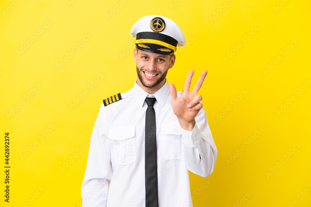 Airplane caucasian pilot isolated on yellow background happy and counting three with fingers Airplane caucasian pilot isolated on yellow background happy and counting three with fingers