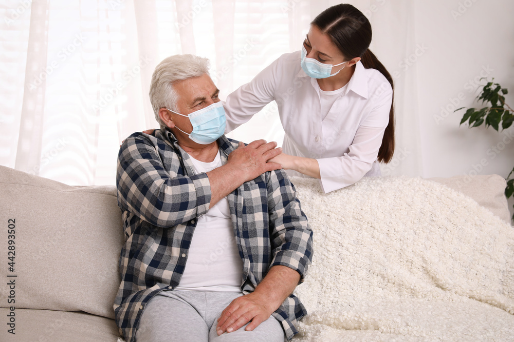 Doctor taking care of senior man with protective mask at nursing home Doctor taking care of senior man with protective mask at nursing home