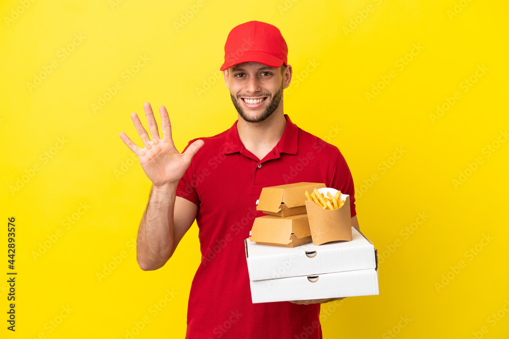 pizza delivery man picking up pizza boxes and burgers over isolated background counting five with fingers pizza delivery man picking up pizza boxes and burgers over isolated background counting five with fingers