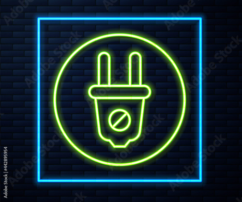 Glowing neon line Electric plug icon isolated on brick wall background. Concept of connection and disconnection of the electricity. Vector