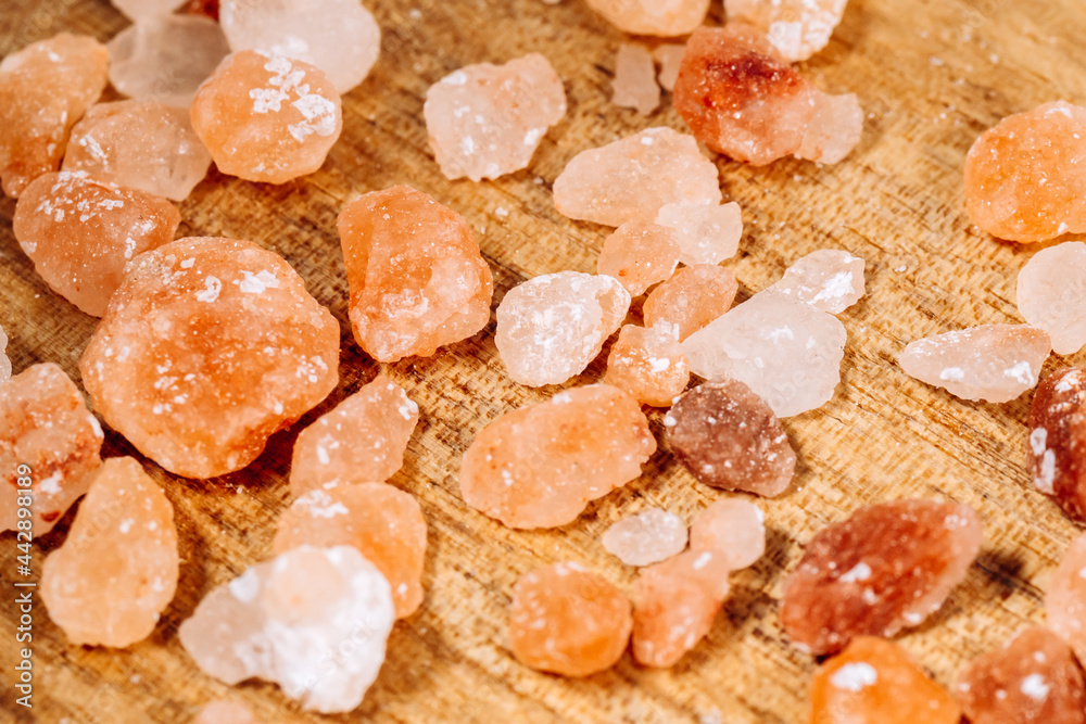 Strewing himalayan pink salt crystals close up. Cooking and Healthcare concept. Selective focus. Strewing himalayan pink salt crystals close up. Cooking and Healthcare concept. Selective focus.