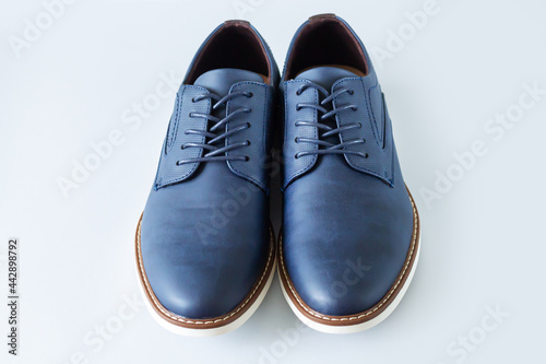 Classic men leather casual blue shoes on gray background