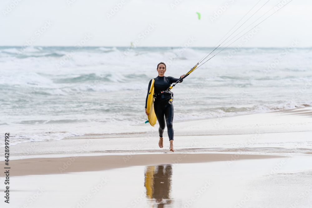 Kitesurfer with kiteboard on sea coast in stormy weather Stock Photo