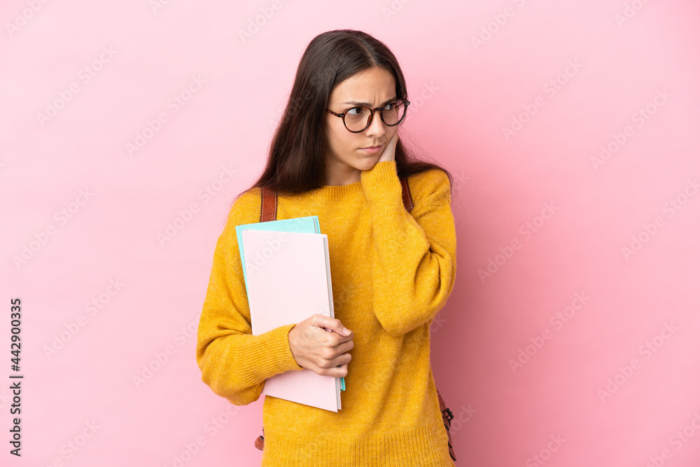 Young student woman over isolated background frustrated and covering ears Young student woman over isolated background frustrated and covering ears