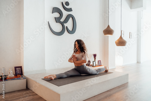 Calm woman doing yoga in Splits pose