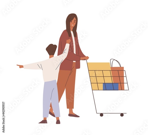 Mother and child during shopping. Woman and kid pushing supermarket cart full...