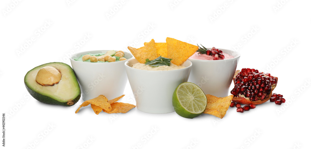 Different kinds of tasty hummus, nachos and ingredients on white background Different kinds of tasty hummus, nachos and ingredients on white background