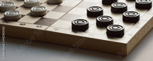 checkers. a board game for brains, strategy. black and white figures.