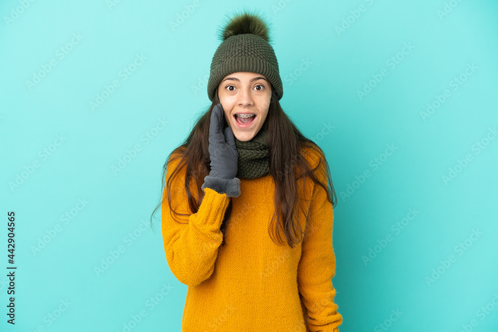 Young French girl isolated on blue background with winter hat with surprise  and shocked facial expression Photos | Adobe Stock