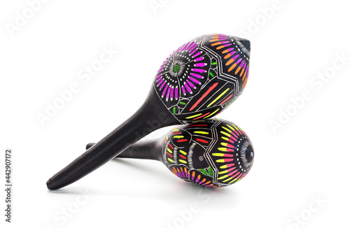Pair of colorful maracas on white background photo