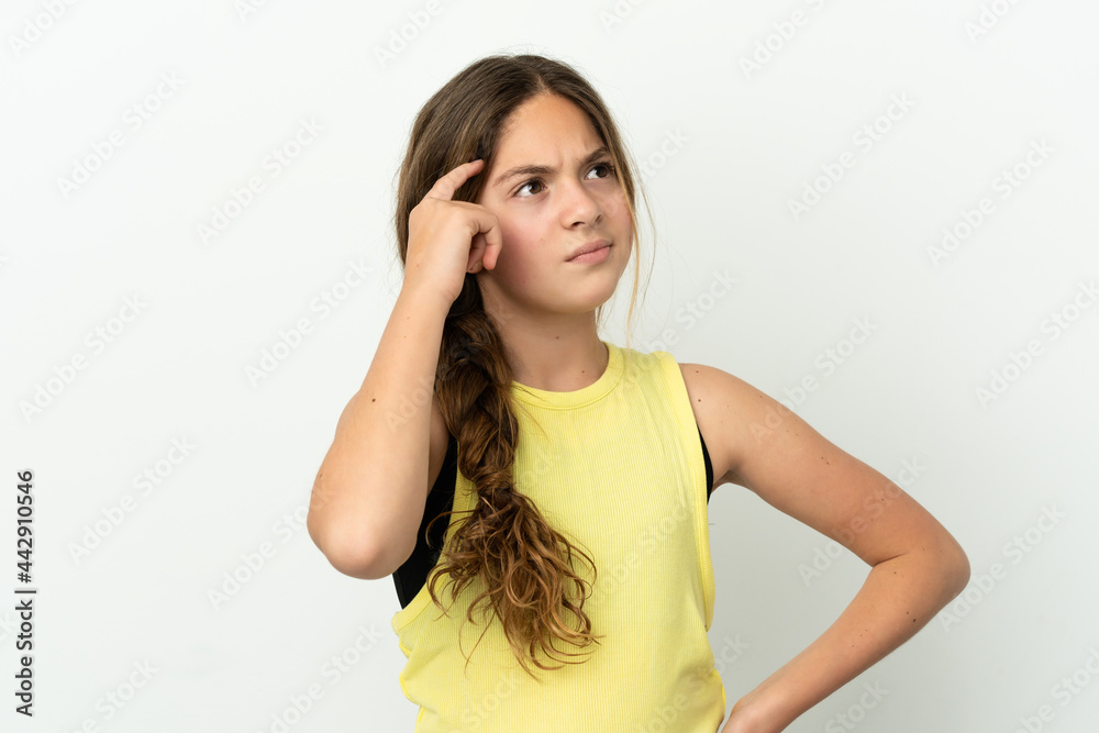 Little caucasian girl isolated on white background having doubts and with confuse face expression Little caucasian girl isolated on white background having doubts and with confuse face expression