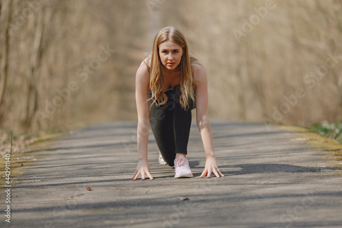 Sports girl training in a summer forest