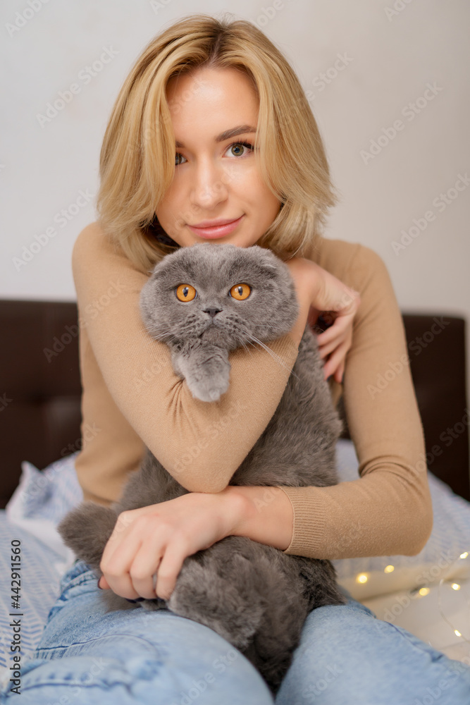 Pets, morning, comfort, rest and people concept - happy young woman with cat in bed at home Pets, morning, comfort, rest and people concept - happy young woman with cat in bed at home