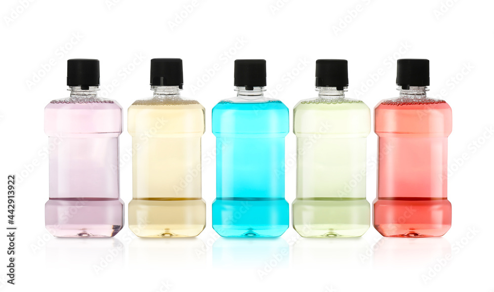 Bottles with mouthwash for teeth care on white background