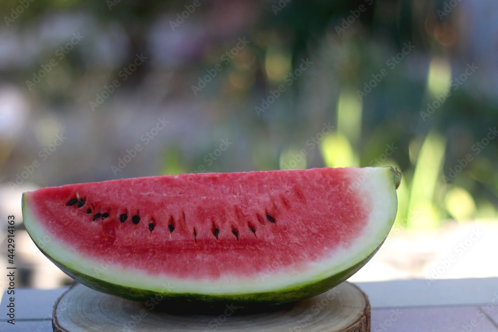 Slice of watermelon, served in a garden. Selective focus. Slice of watermelon, served in a garden. Selective focus.