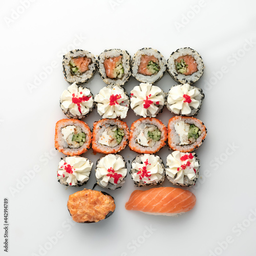 Festive Sushi and Sashimi Set, rolls isolated on white background. Classic Japanese seafood. Healthy Oriental meal. Wellness concept. Flat lay. Top view. Copy space.