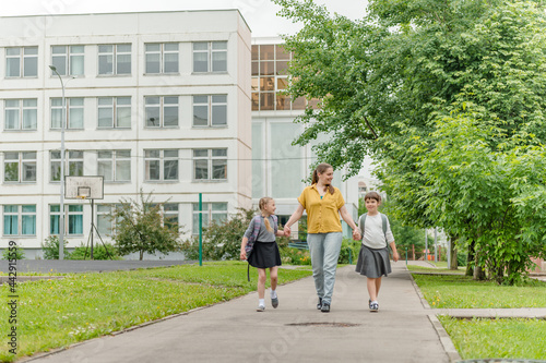 Wallpaper Mural two little happy girl with mom go to school education concept. High quality photo Torontodigital.ca