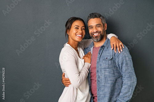 Mature multiethnic couple embracing and smiling together