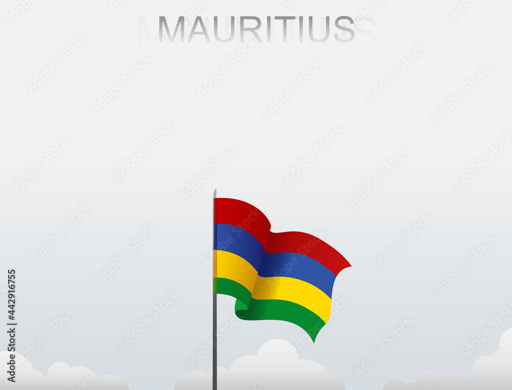 The flag of Mauritius flies on a pole that stands tall against a white sky The flag of Mauritius flies on a pole that stands tall against a white sky