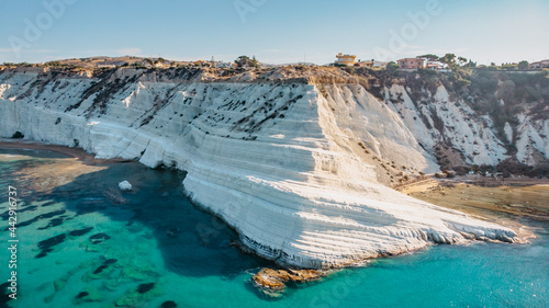 Scala dei Turchi,Sicily,Italy.Aerial view of white rocky cliffs,turquoise clear water.Sicilian seaside tourism,popular tourist attraction.Limestone rock formation on coast.Travel holiday scenery photo