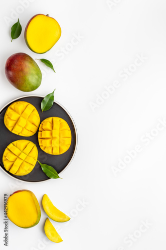 Plate of mango fruits and mango cubes. Tropical breakfast. Top view