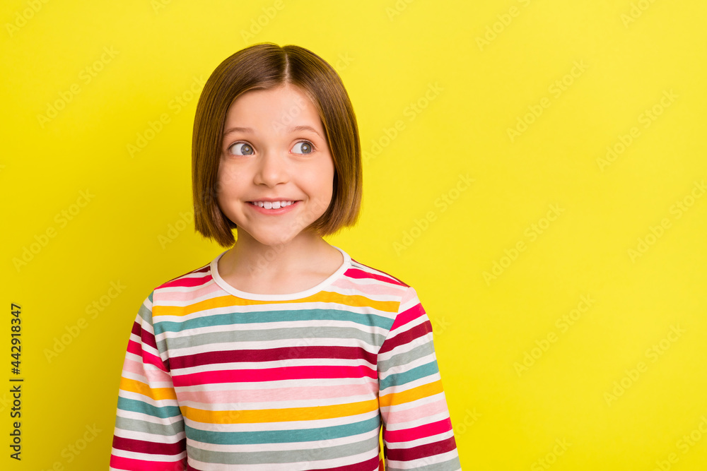 Photo portrait little girl in striped clothes smiling looking copyspace isolated bright yellow color background Photo portrait little girl in striped clothes smiling looking copyspace isolated bright yellow color background