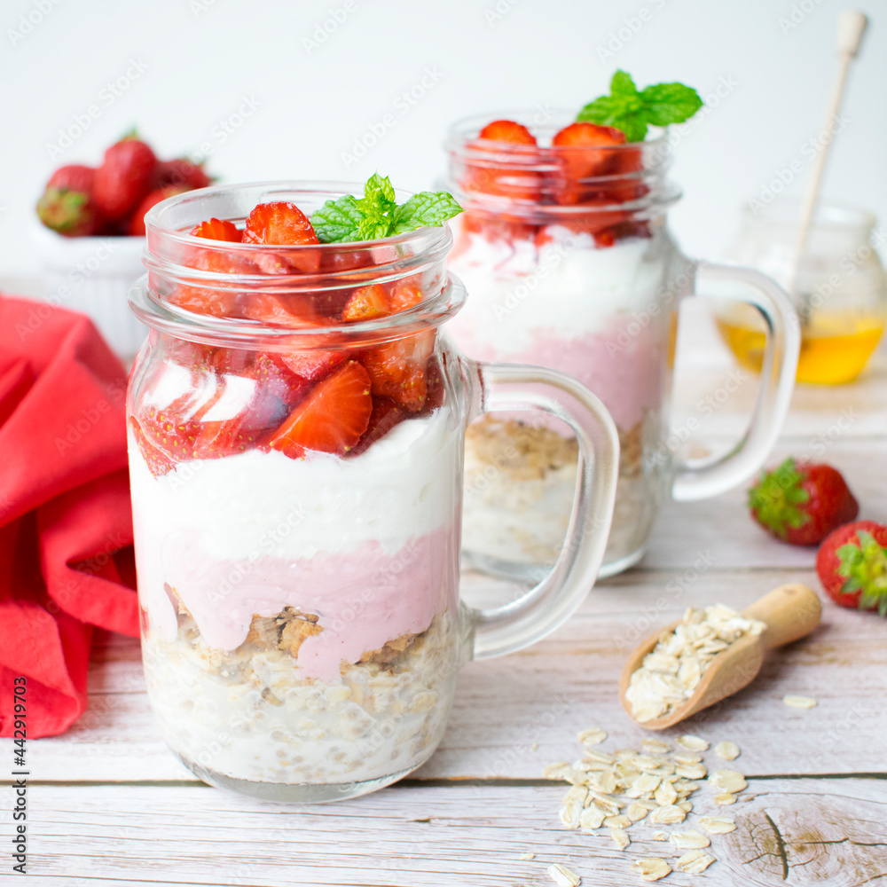A proposal of a healthy breakfast prepared at home. Oatmeal with granola, Greek yogurt, and strawberries. A proposal of a healthy breakfast prepared at home. Oatmeal with granola, Greek yogurt, and strawberries.