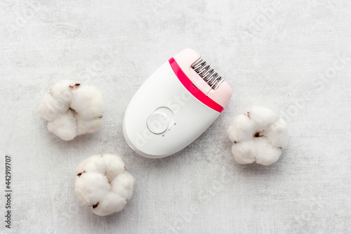 White epilator with cotton flowers for hair removal, top view