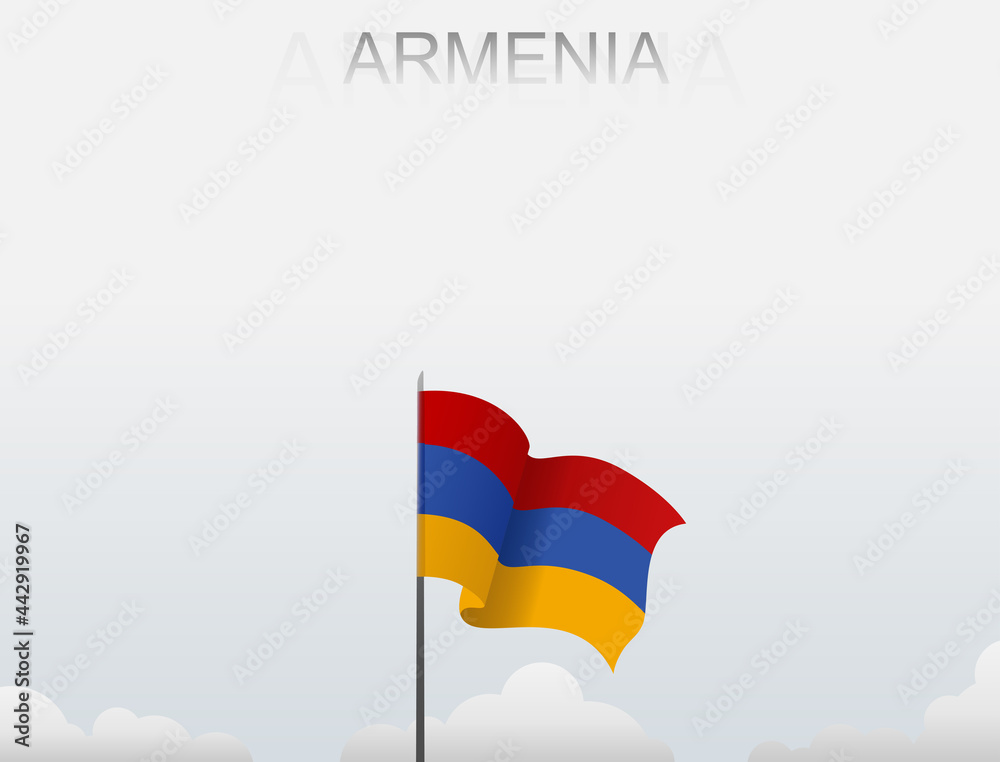 Naklejka premium Armenian flag flutters on a pole standing tall under a white sky